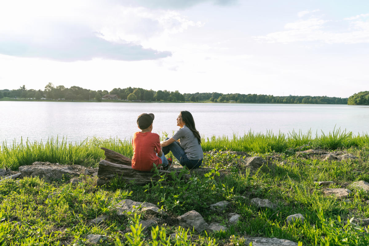 a mother and son relaxing by freeman lake