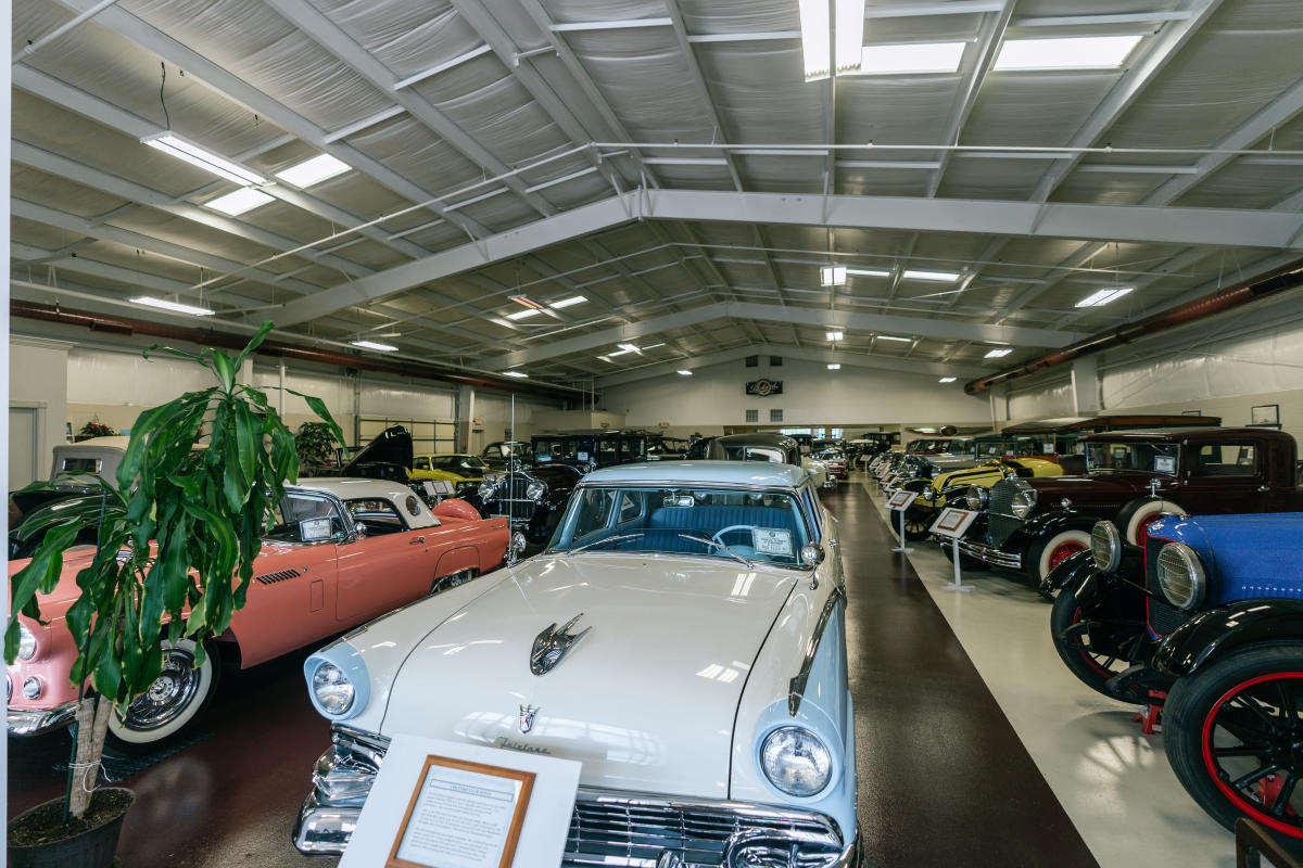 a room full of classic vehicles at swope cars of yesteryear museum