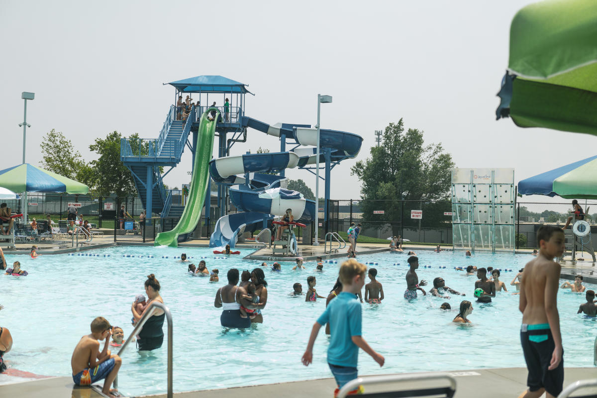 shot of the water slides and pool with people at the water park