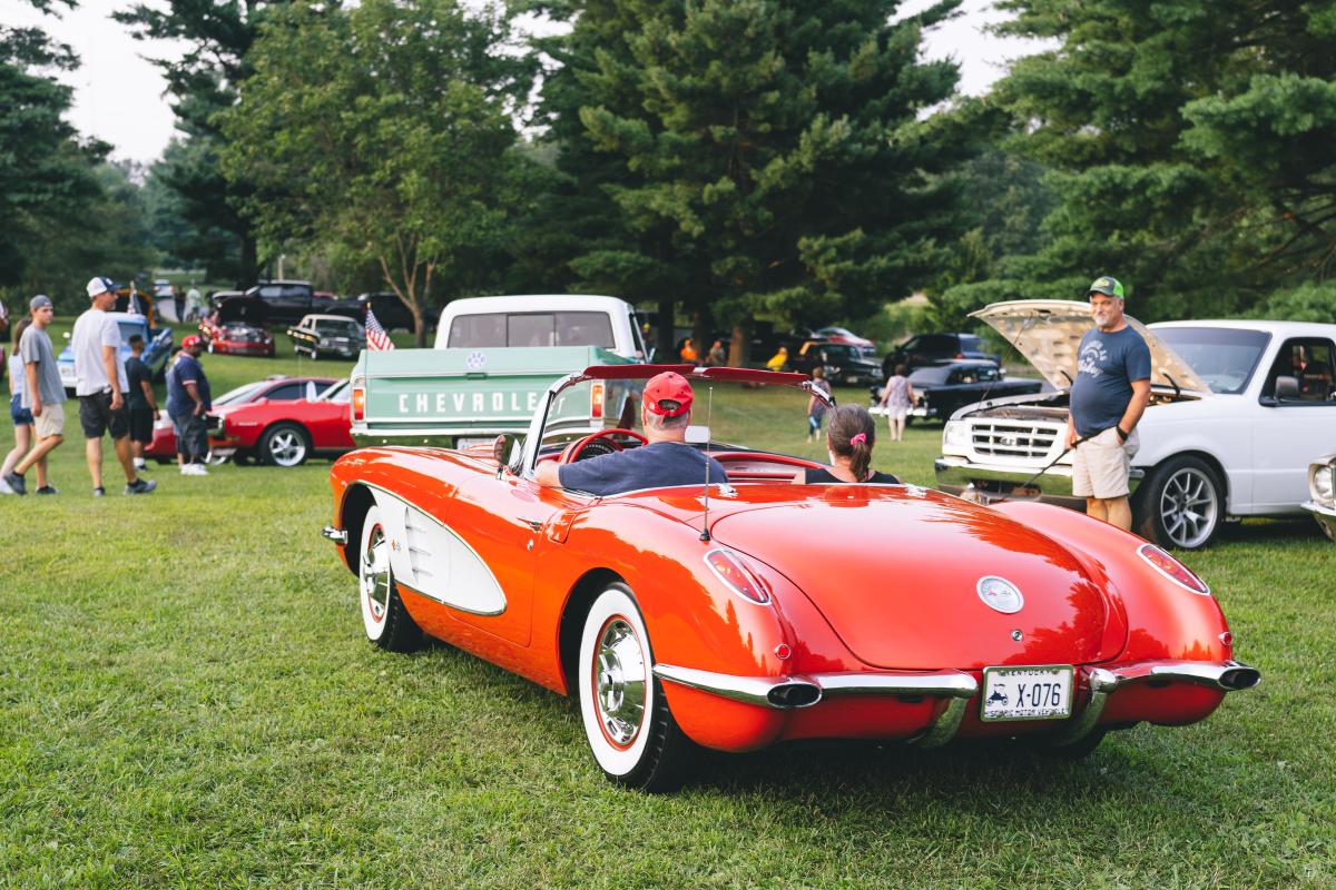 a couple driving a car at the cruisin the heartland car show
