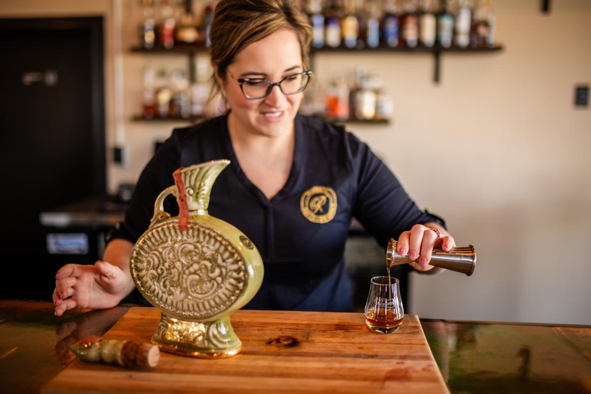 Bartender pouring a drink at Revival Vintage Spirits Bar in Downtown Elizabethtown, KY.