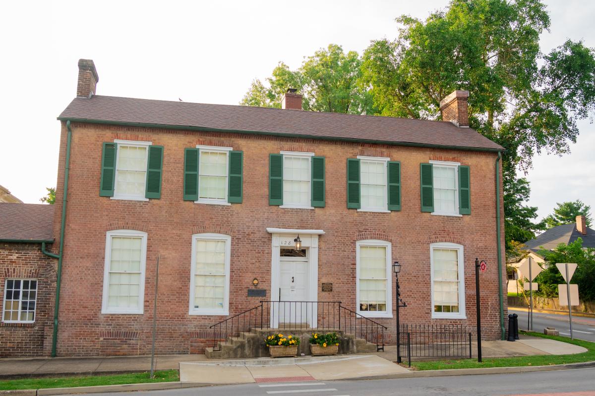 Historic brick building with green shutters, located in Elizabethtown, Kentucky, on a quiet street corner