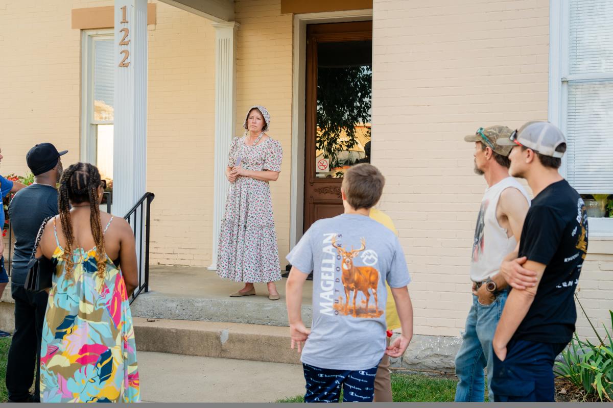 Group of people listening to one of the characters on the Historic Downtown Walking Tour