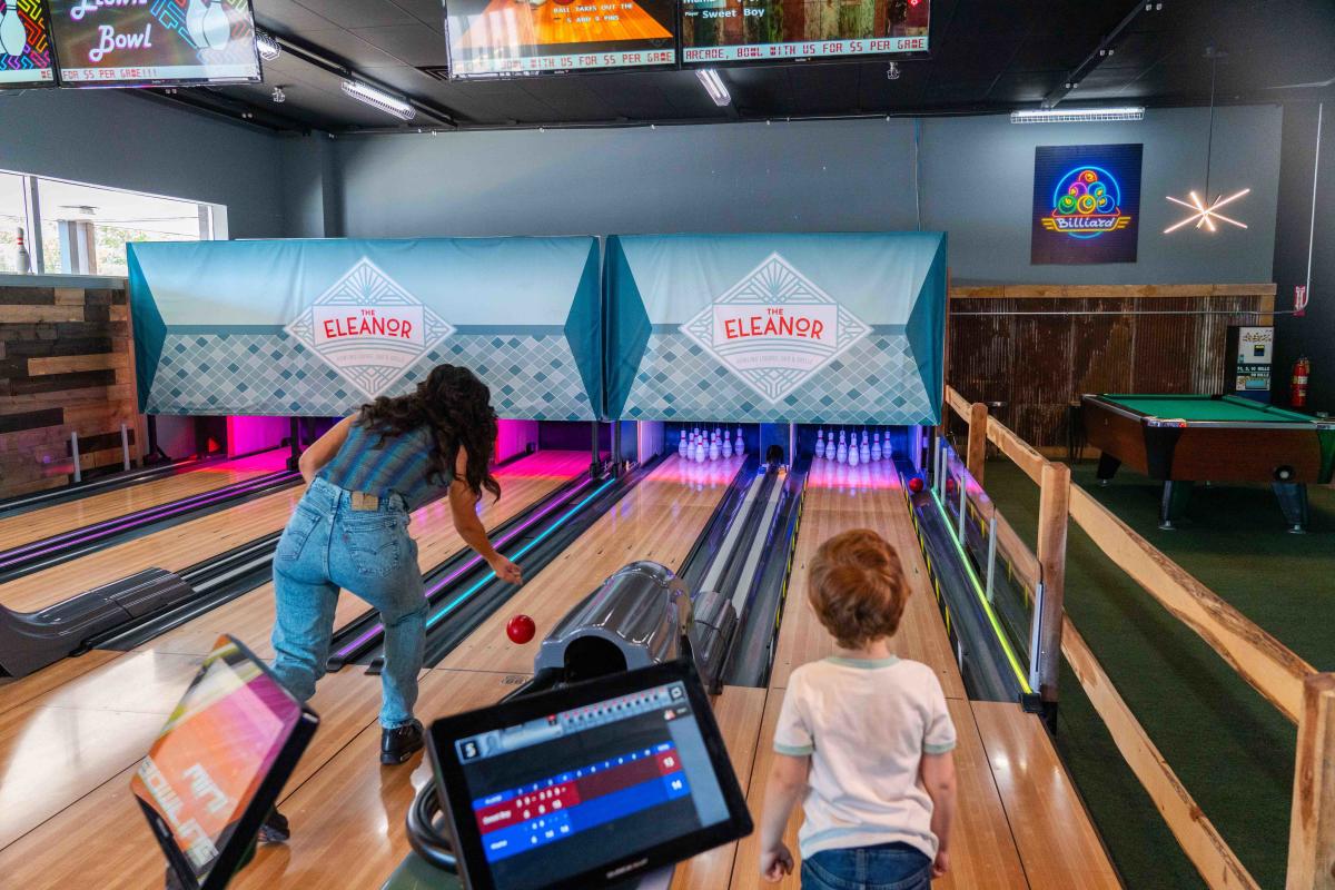 A woman getting ready to roll a bowling ball down the alley in Xtreme Arcade in Elizabethtown, Kentucky