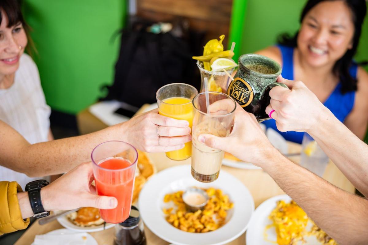 People cheersing at the Toasted Yolk Cafe in Elizabethtown, KY.