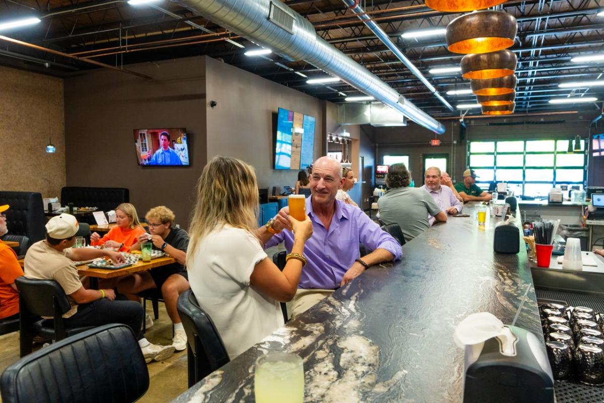 Couple cheersing at the bar at HubHaus in Downtown Elizabethtown, KY.