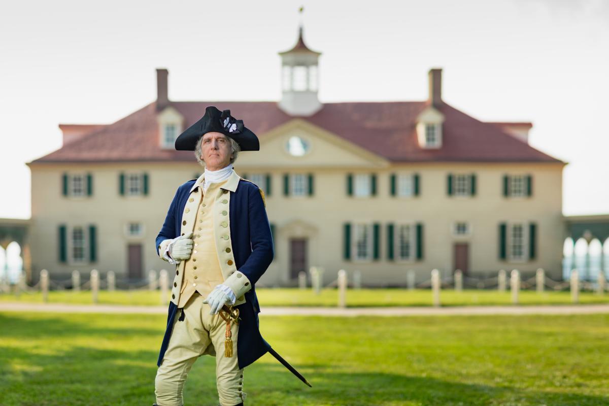 George Washington (interpreter) standing in front of his home, Mount Vernon