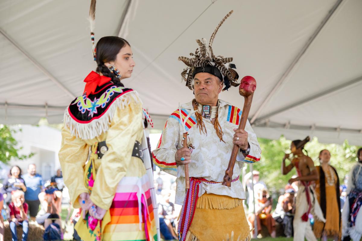 two members of local Native American Tribe in colorful cultural garb