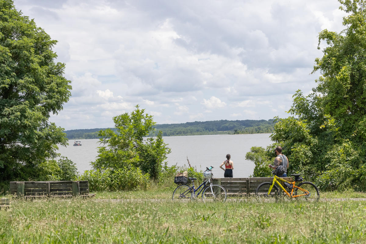 Two Bicyclists Viewing the Potomac River on the Mount Vernon Trail.