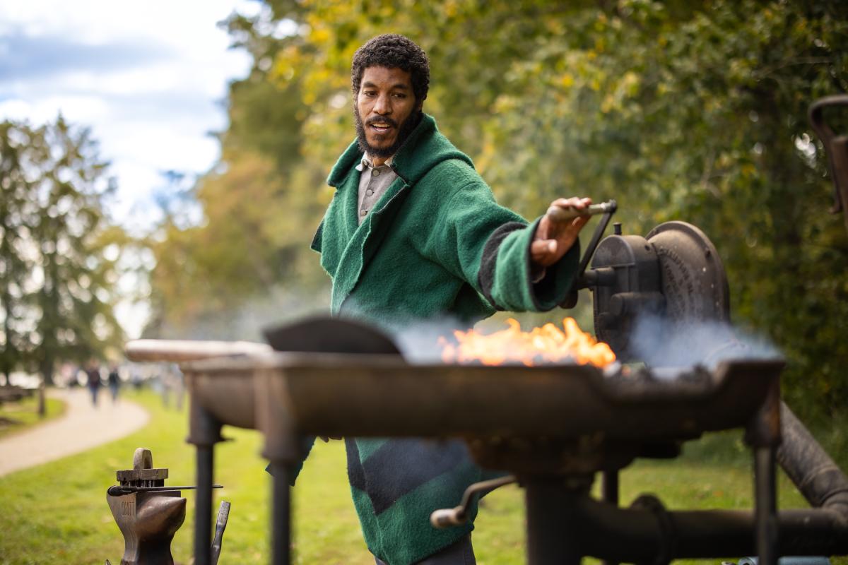 Interpretive Character working with fire.