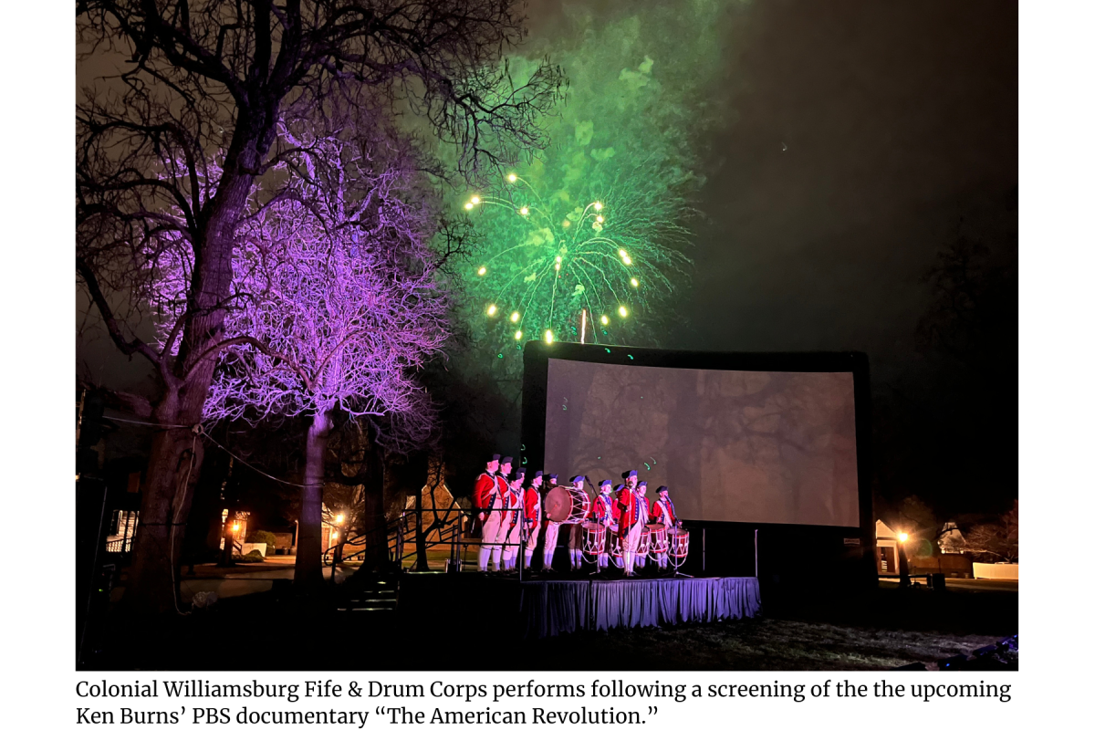 Colonial soldiers standing on stage with fireworks in background at the VA250 event in Williamsburg, VA