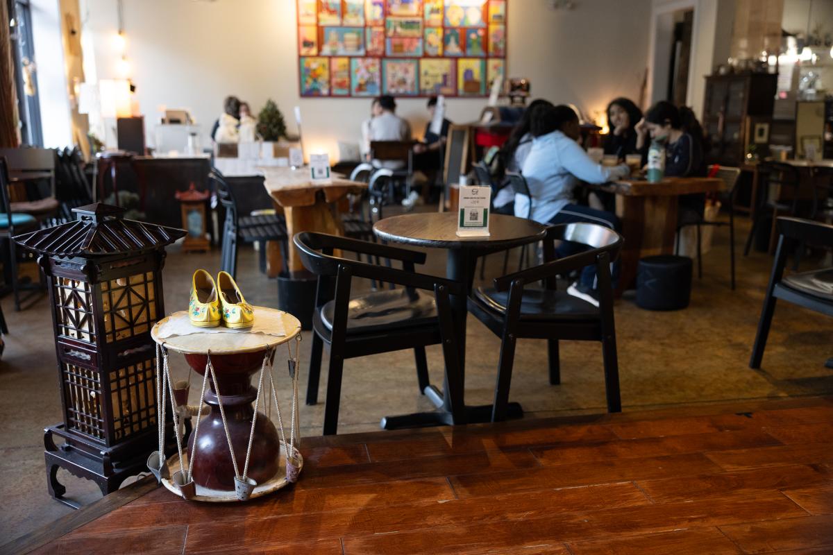 Stage and Props in front of several cafe goers at Soricha Tea & Theater