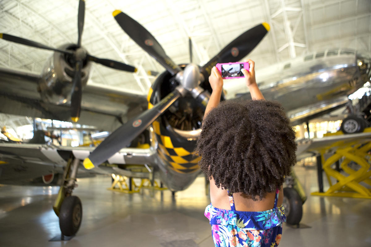 Child taking an image of a plane.