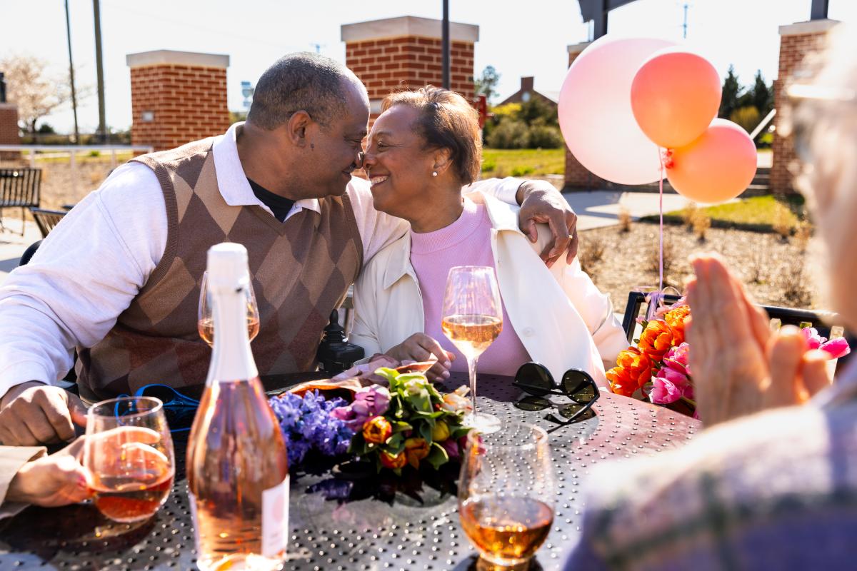 Older Couple Happily in Love with Wine and Balloons