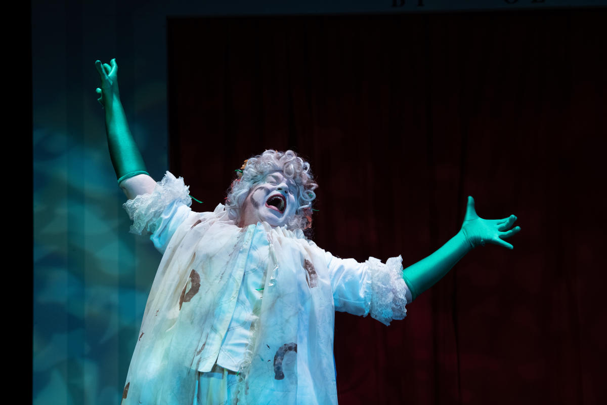 A performer singing at a Bas Bleu Performance