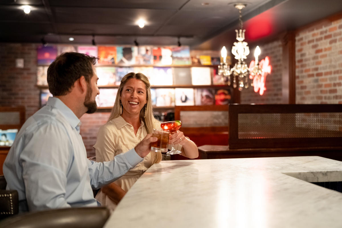 A couple enjoying cocktails at Ace Gillett's Lounge