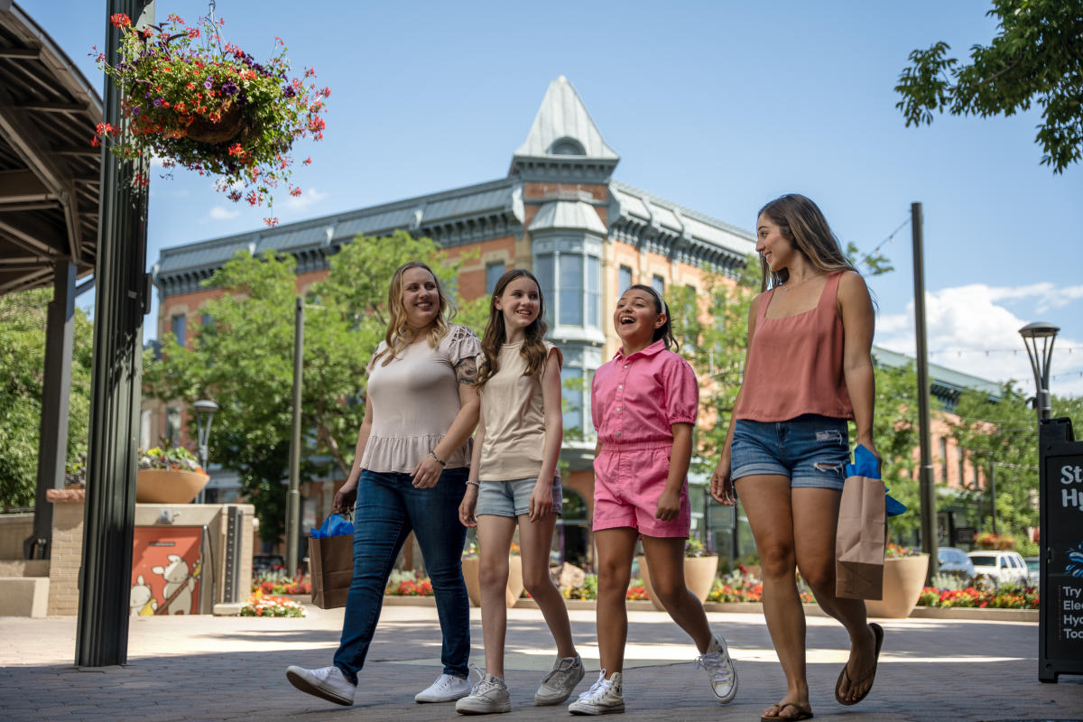 A family does summer shopping at Old Town Square with Linden in the background