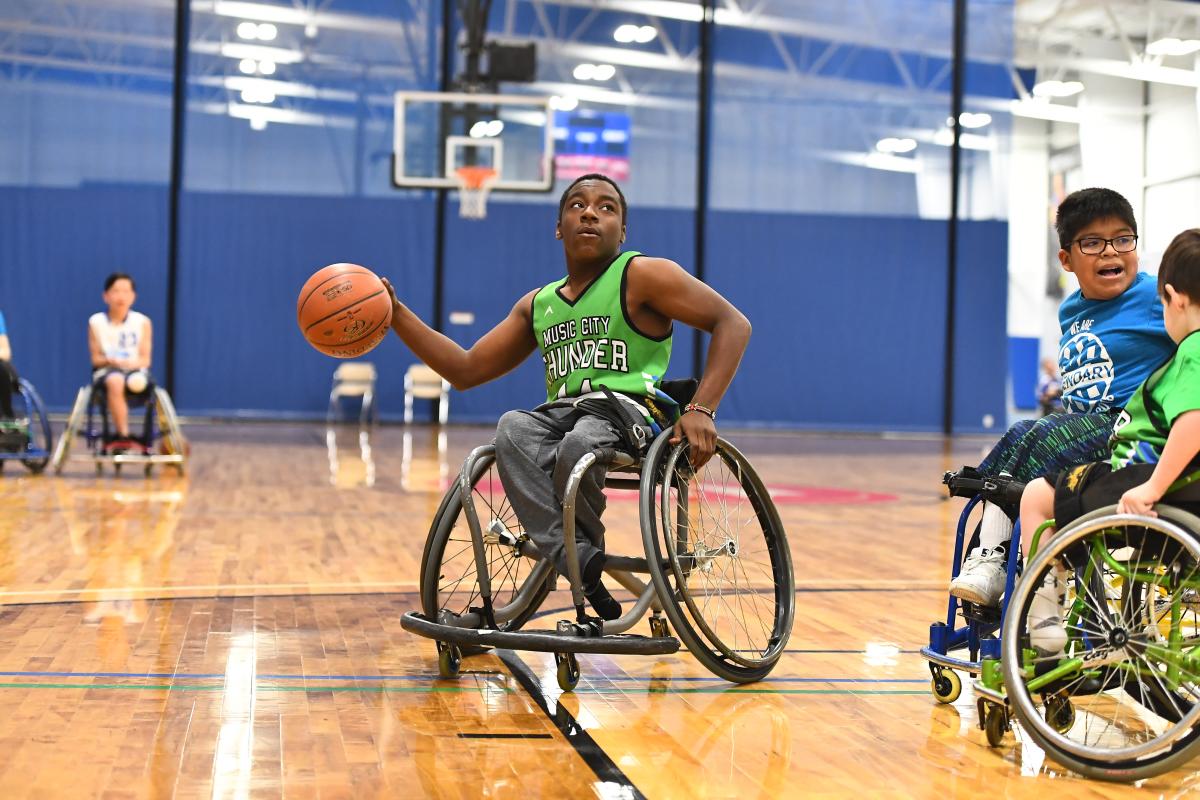 man playing wheelchair basketball man playing wheelchair basketball