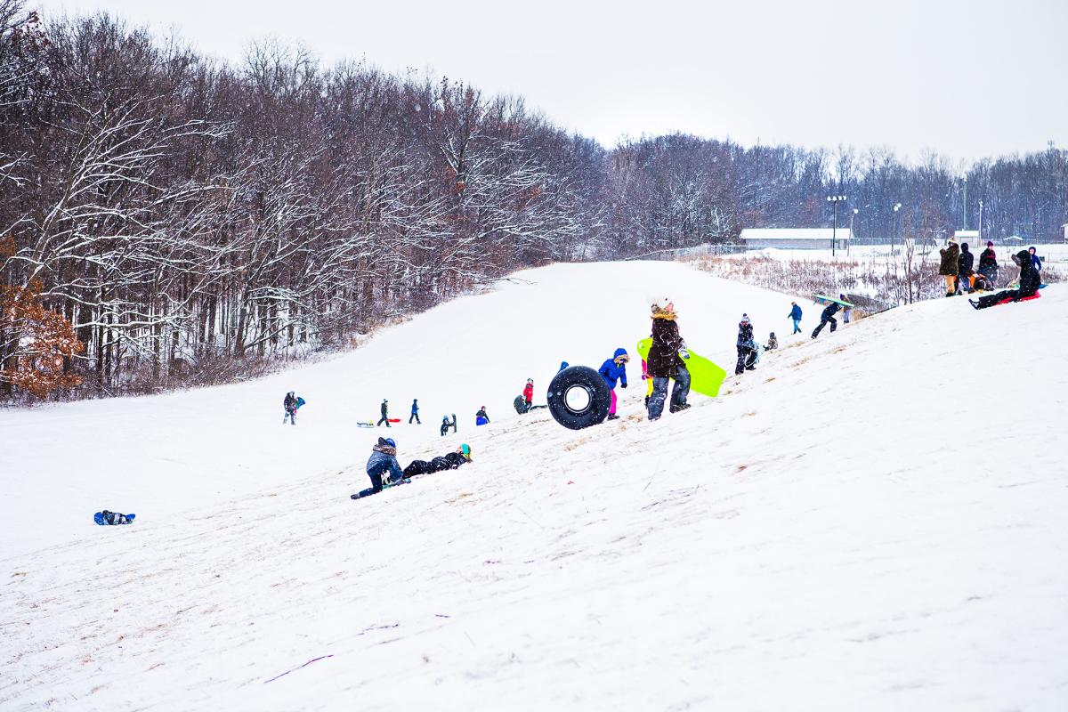 People sledding down the hill at Shoaff Park in Fort Wayne