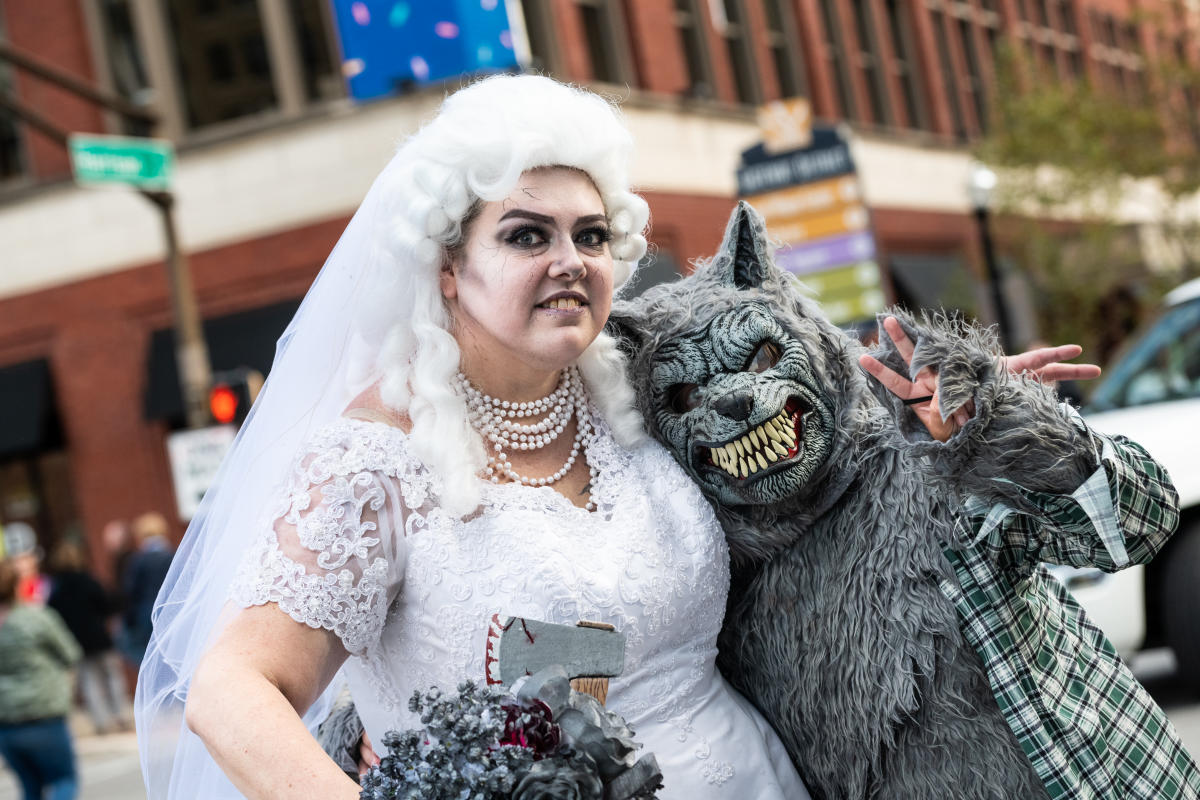 couple in halloween costumes as a zombie bride and warewolf