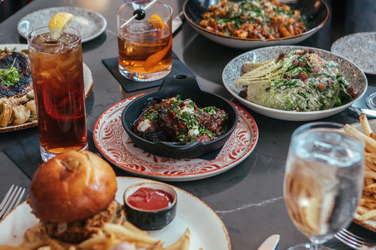 A table full of tasty dinner options from Amoré in downtown Fort Wayne. Setting includes drinks, salads, sandwhich, and pasta dishes. A table full of tasty dinner options from Amoré in downtown Fort Wayne. Setting includes drinks, salads, sandwhich, and pasta dishes.