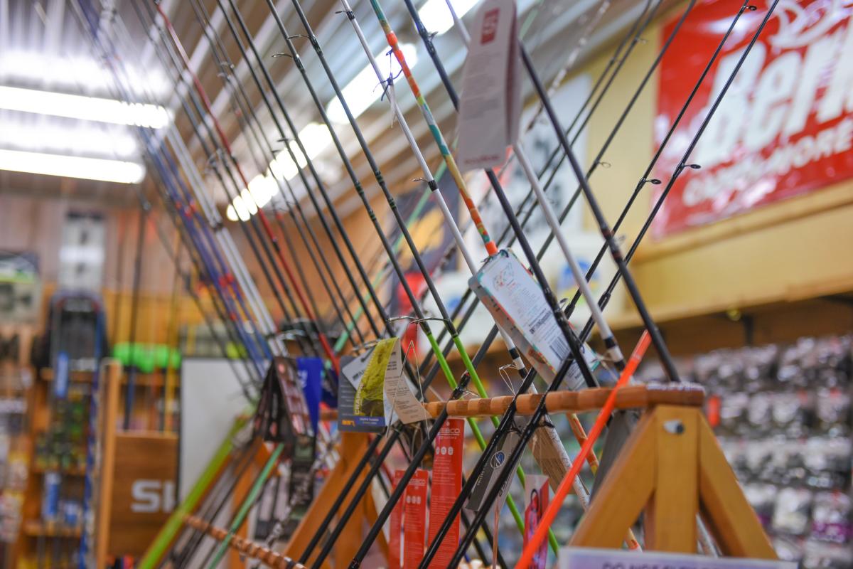 A close-up of fishing rods posed to form an X modeled in the middle of the store.