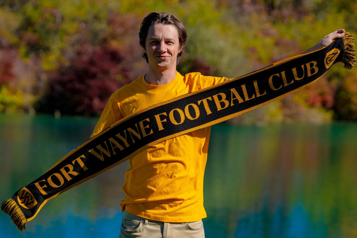 Man holding scarf of the Fort Wayne Football Club