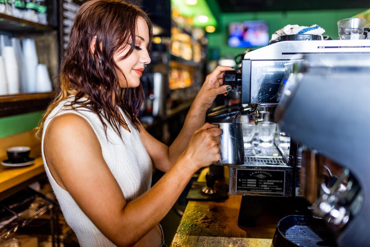 A view of a woman pouring a coffee at Cafe Nola