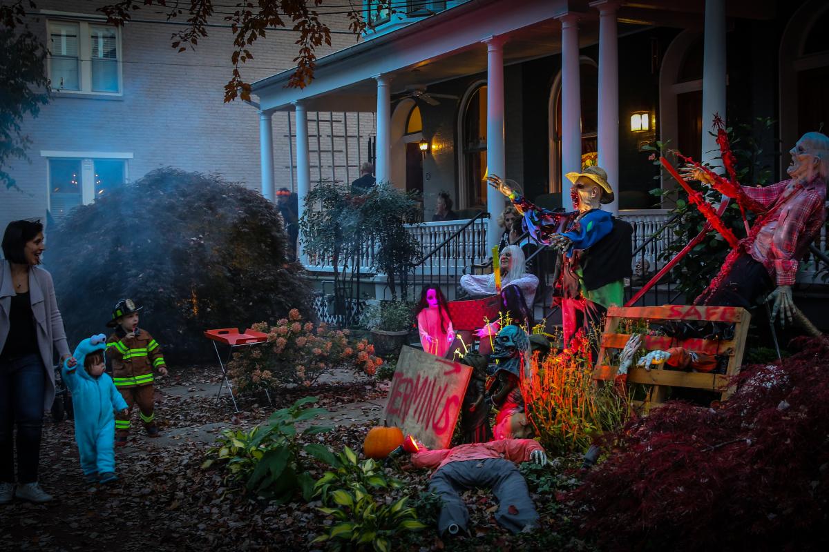 Kids trick-or-treating at a spooky house