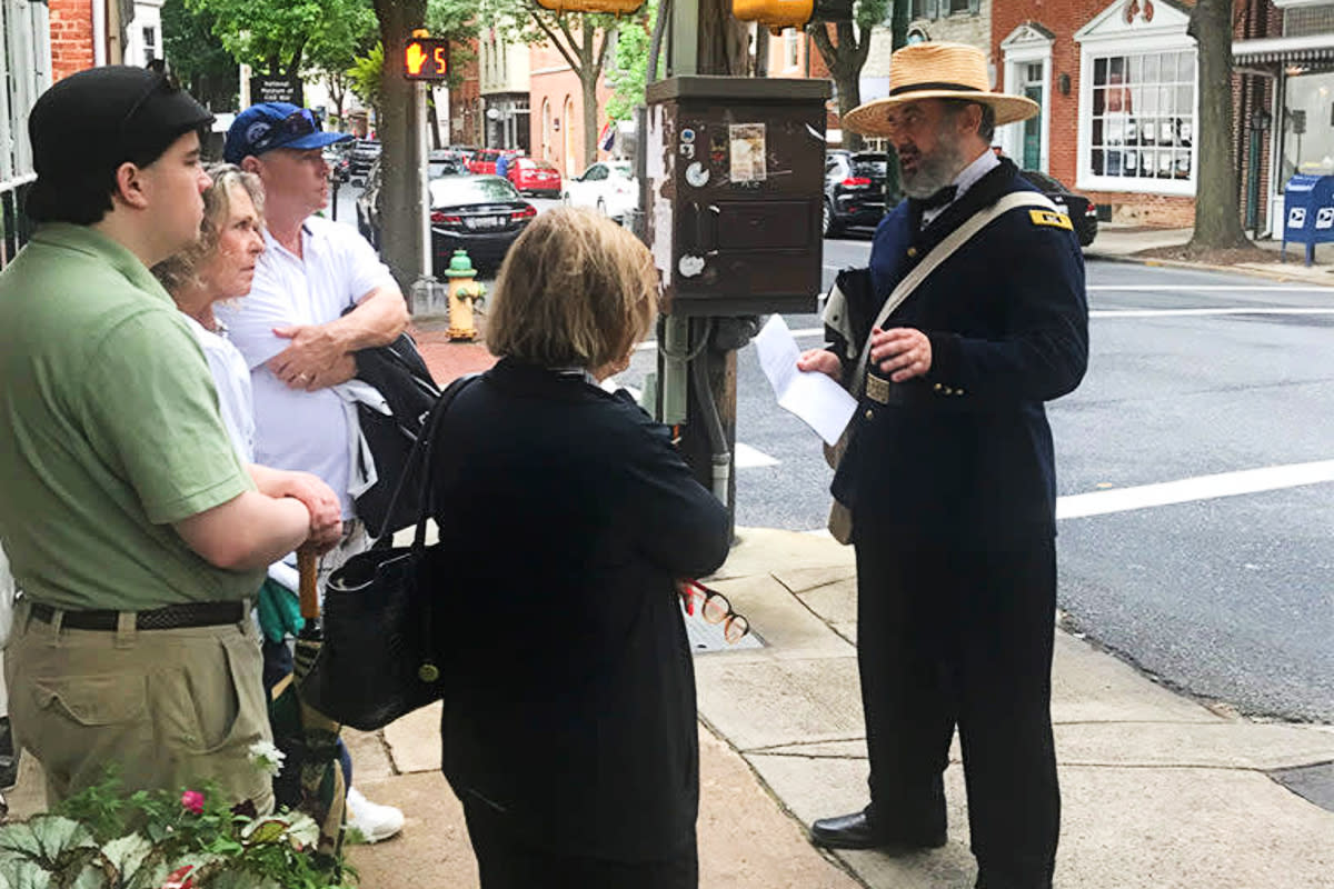 Walking Guide with group on One Vast Hospital Walking Tour