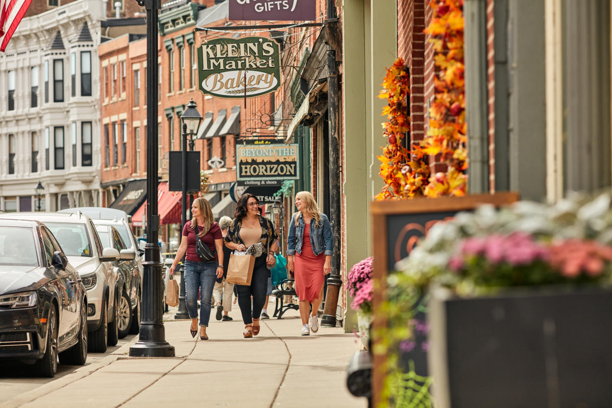 Three people walking down Main Street in Galena Illinois, in the Fall.