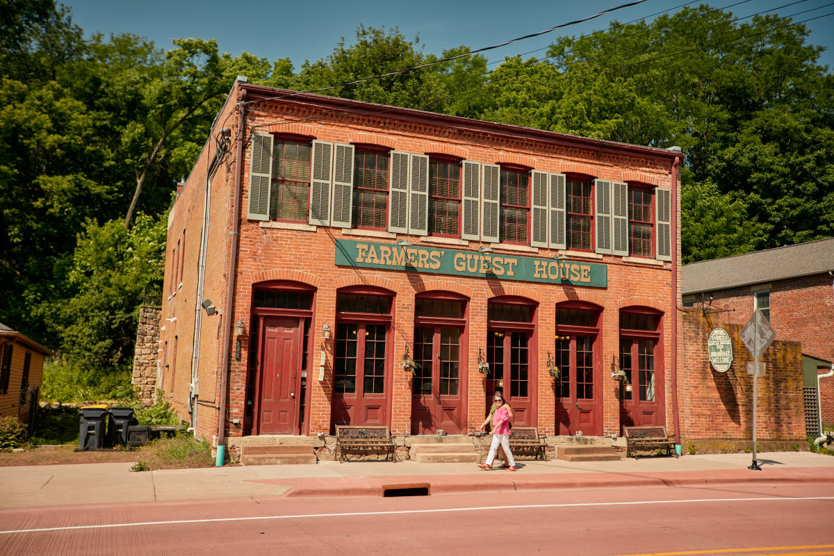 People walking in front of a brick building.