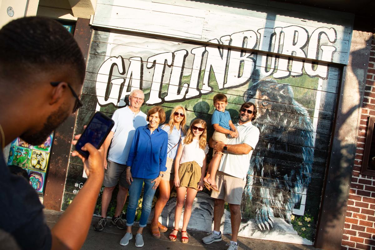 Family in front of Gatlinburg sign