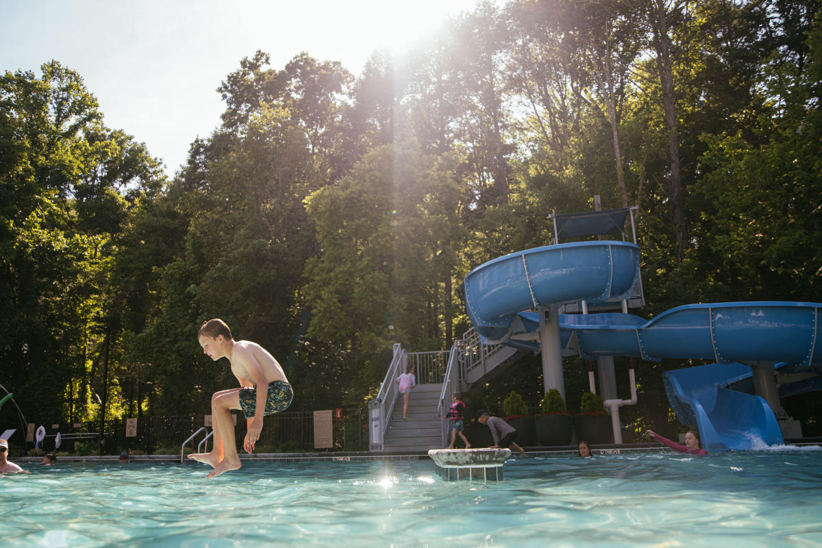 Kid jumping into pool at Embassy Suites hotel