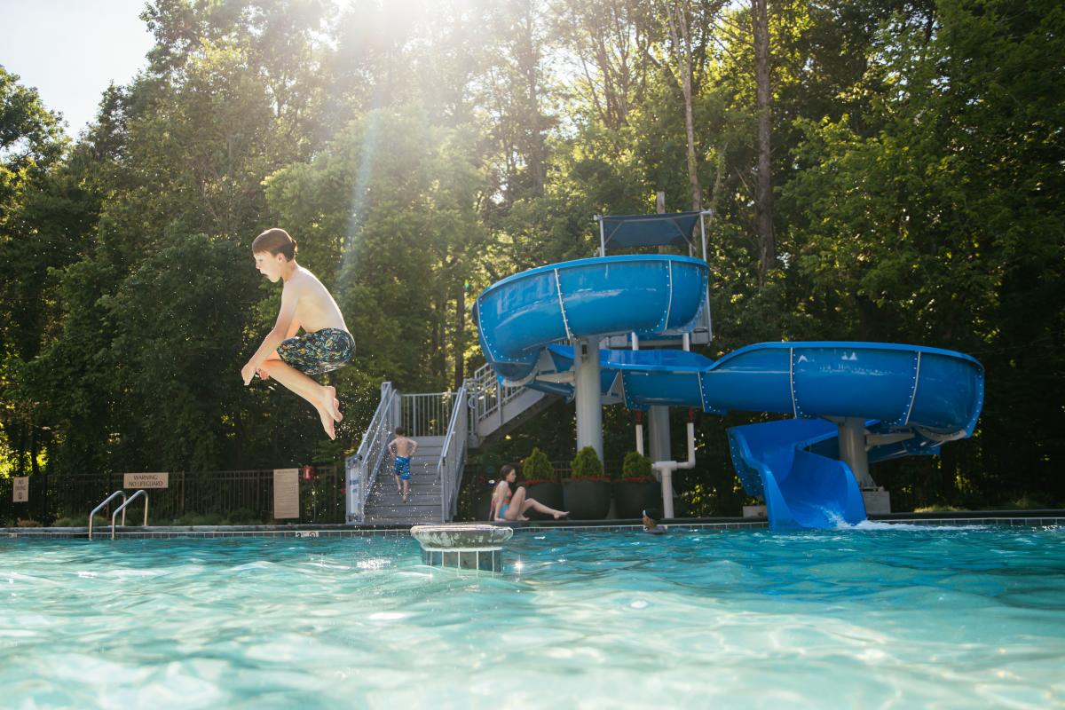 kid jumping in pool