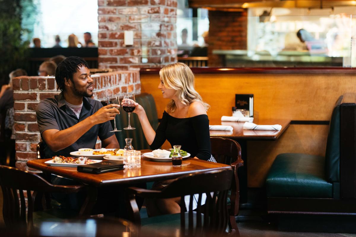 Couple clinking glasses at Cherokee Grill restaurant