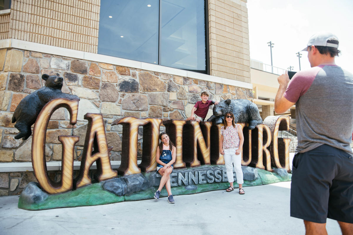 Family in front of Gatlinburg sign
