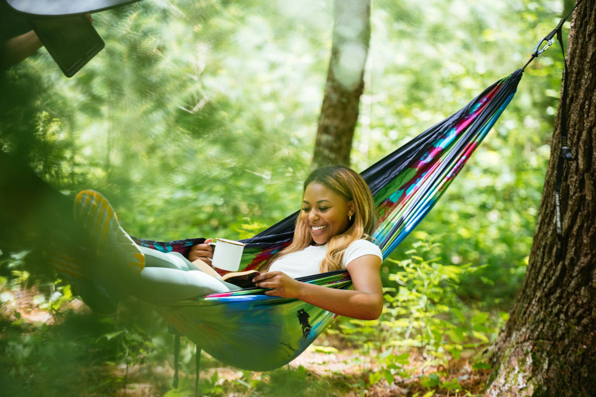 women in hammock in woods
