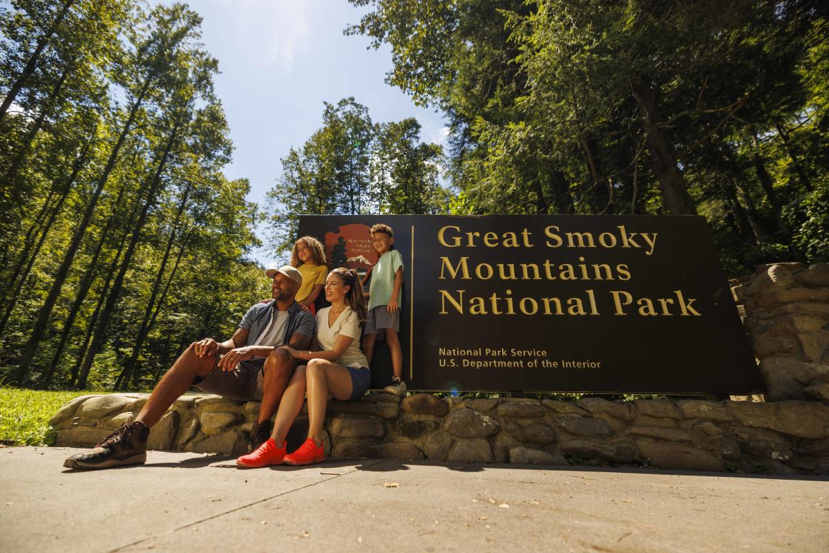 family in front of Smokies sign