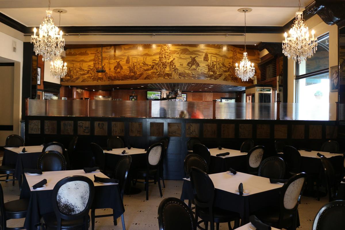 Black tables, chairs and tablecloths at The Milias Restaurant