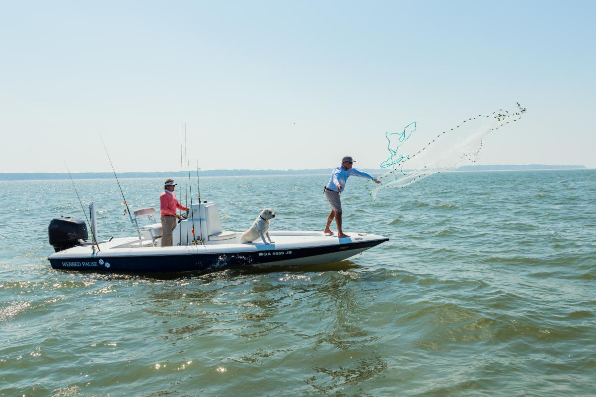 Friends spend an afternoon fishing on the water fishing in the Atlantic Ocean near St. Simons Island, Georgia