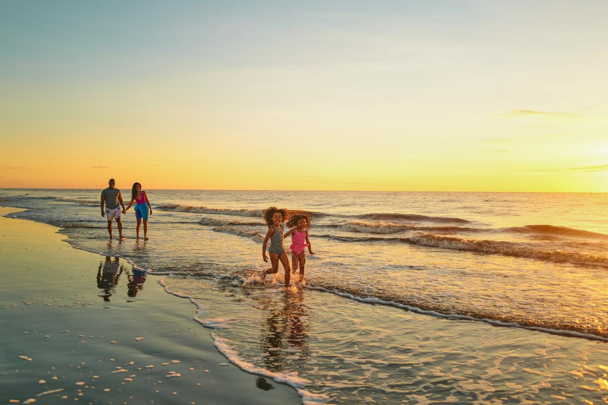 A young family delights in the waves and sunny shores of Georgia beaches.