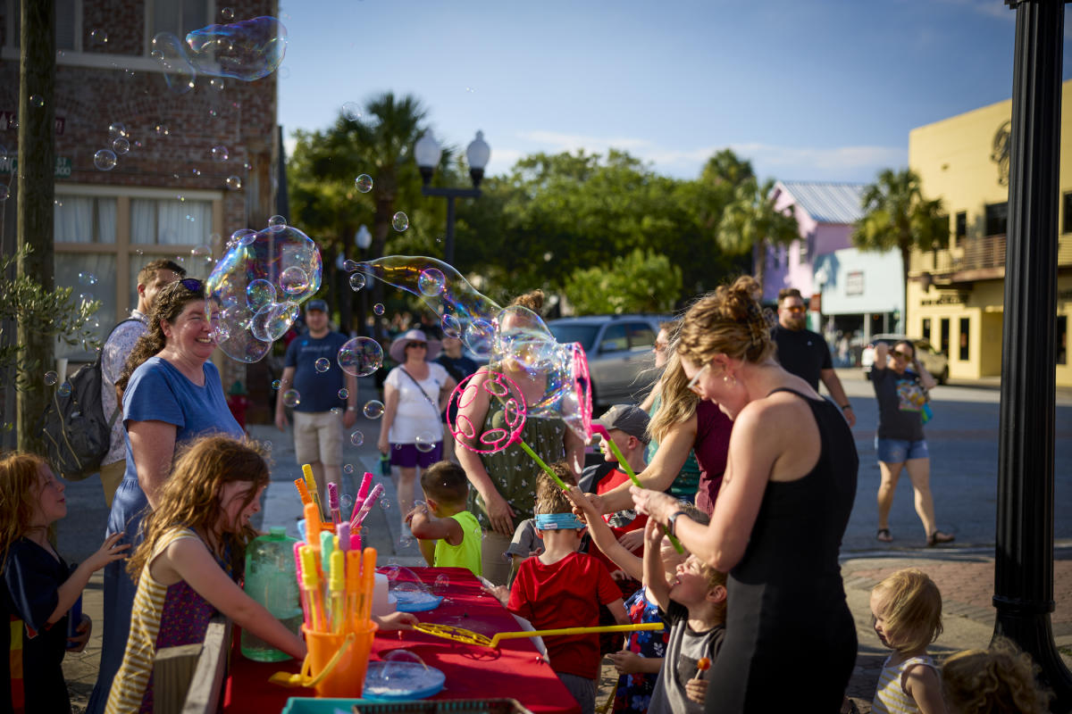 Blowing bubbles at Brunswick's First Friday