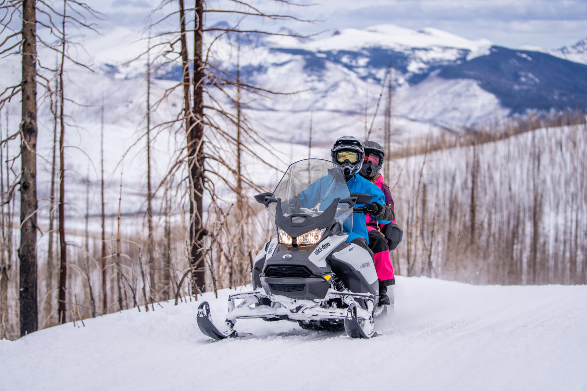 Couple on a snowmobile in Grand Lake, Colorado