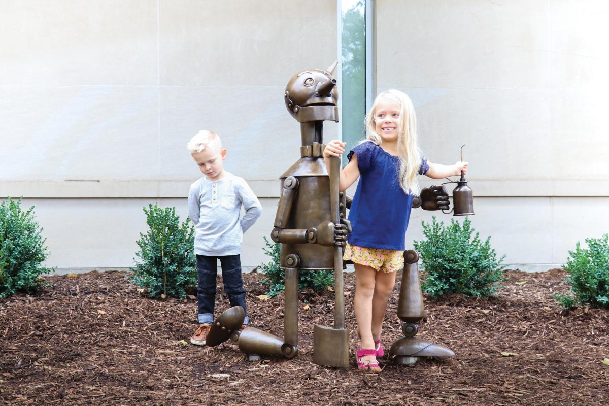 Children climbing on Bronze statue of the Tin Man