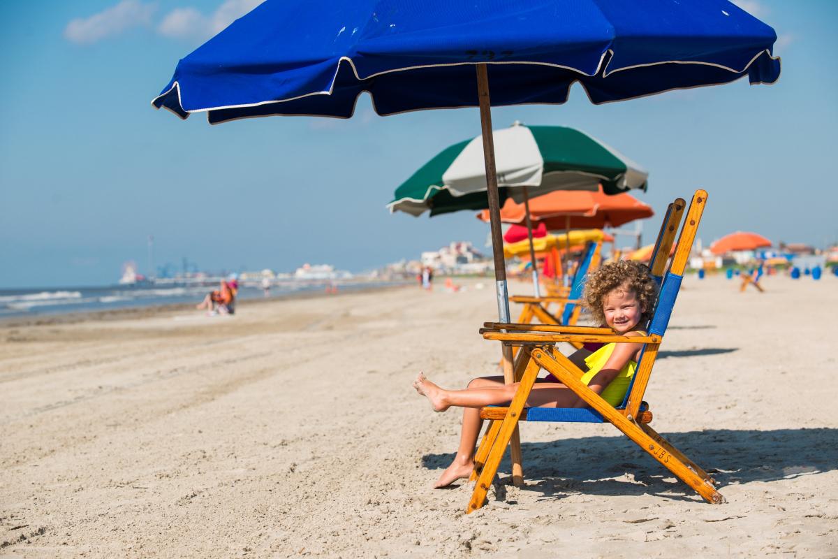 Kids enjoying the beach chairs along Stewart Beach in Galveston, TX