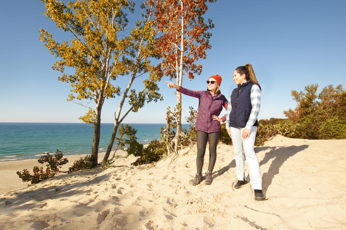 Two Women on the Dunes pointing in Fall