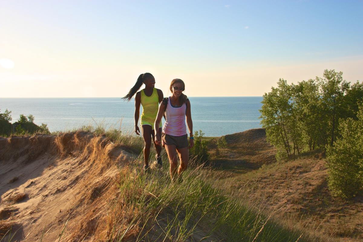 Two women walking through Indiana Dunes State Park
