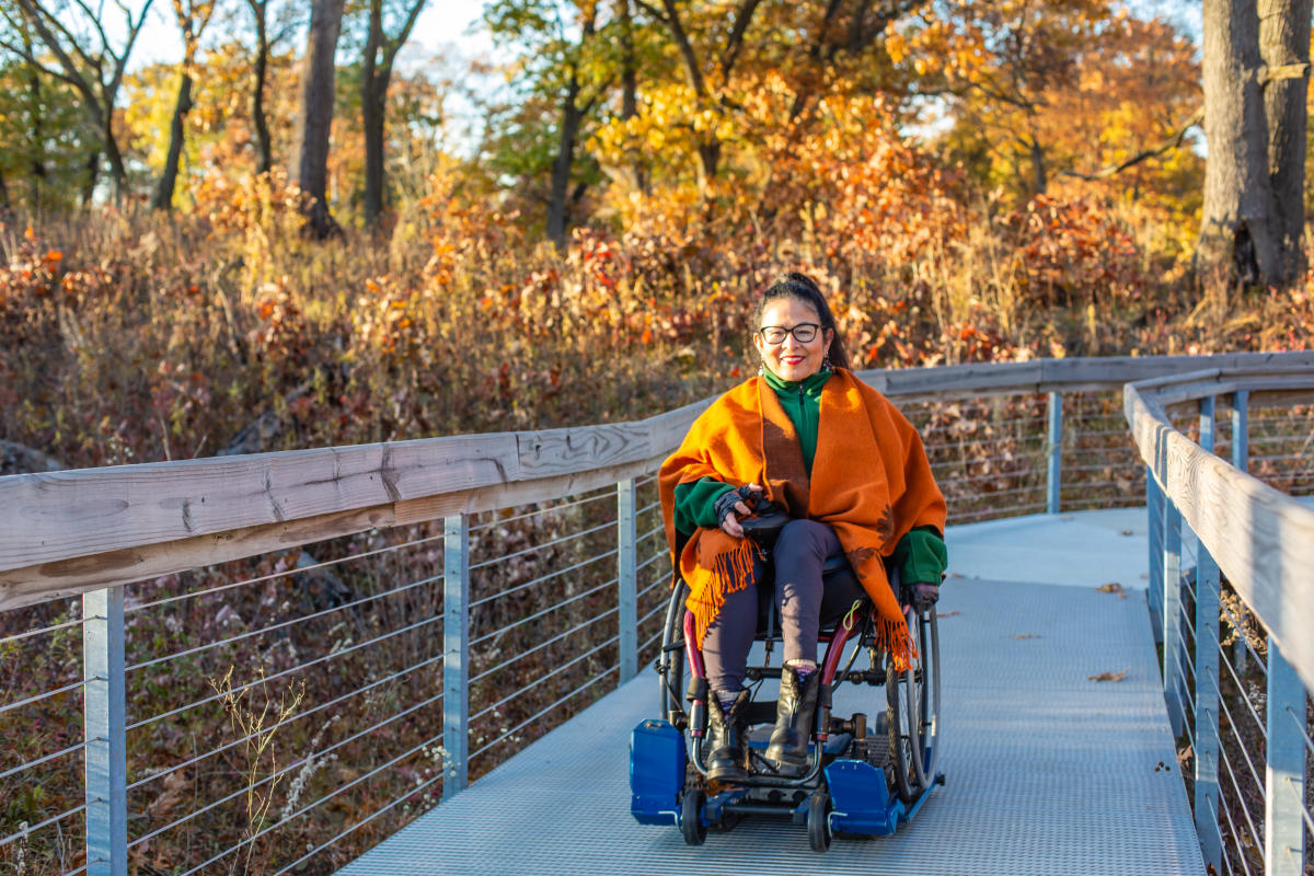 Woman in a wheelchair going through Miller Woods - Indiana Dunes