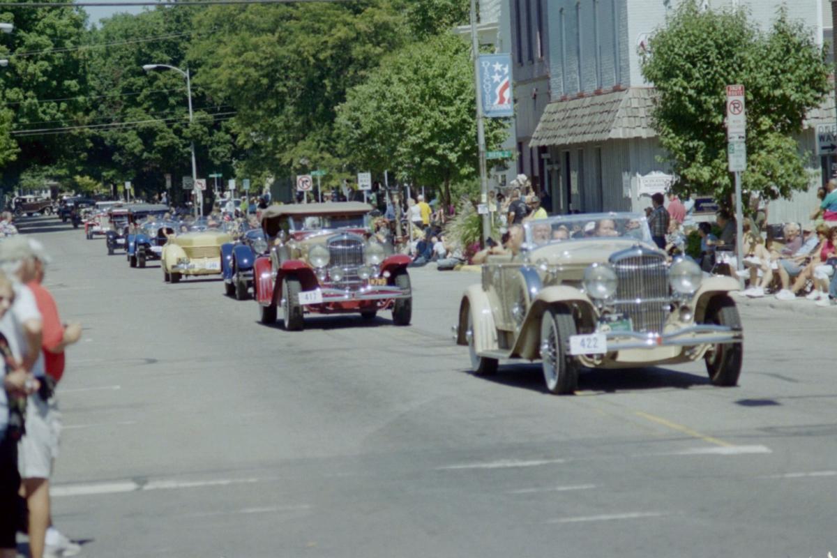 A parade of classic cars at the Auburn Cord Duesenberg Festival in DeKalb County